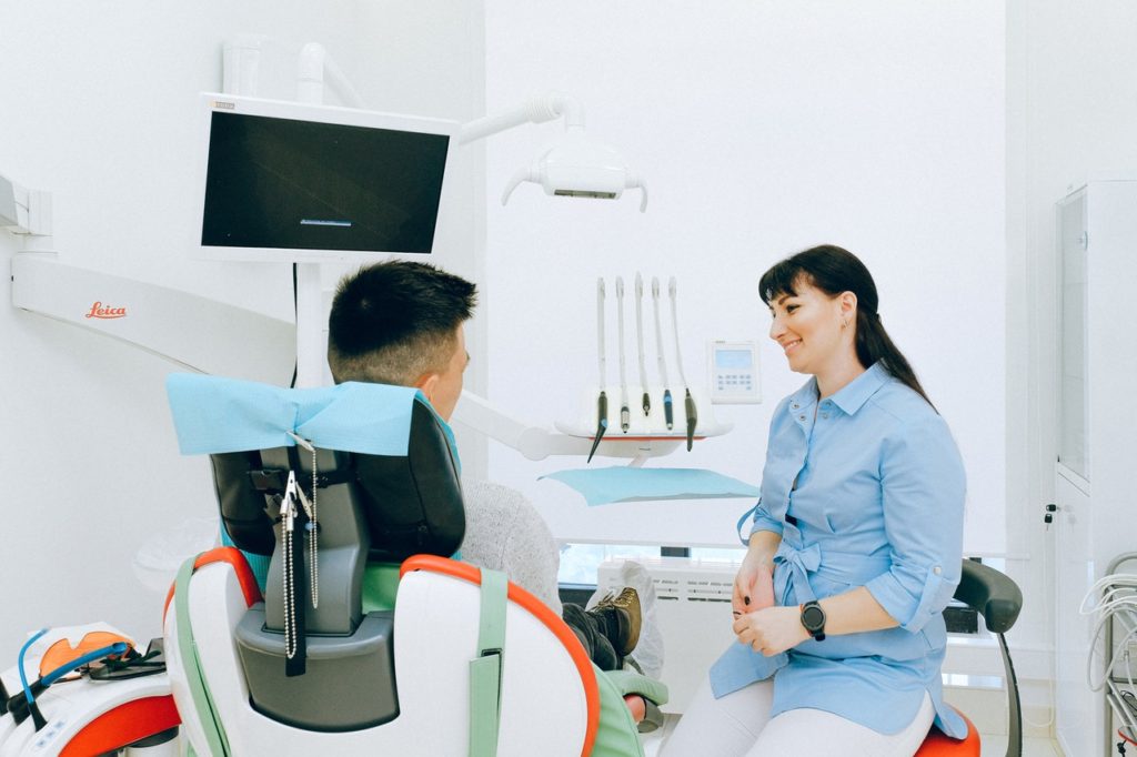 dentist performing oral examination at Blue Dental Health Largo, FL