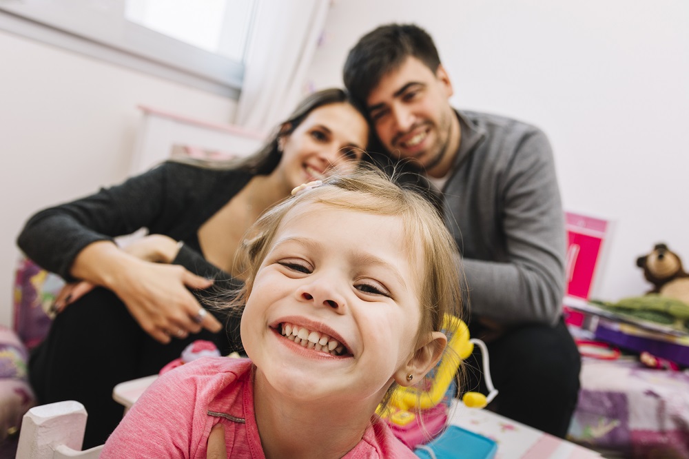 close-up-happy-girl-front-her-parents